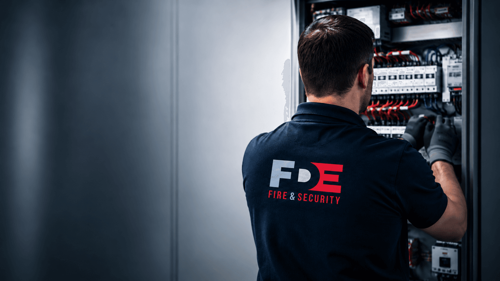 FDE engineer working on an electrical control panel